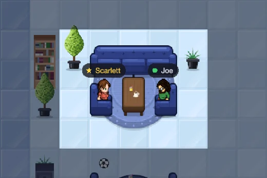 Scarlett and Joe chatting in the armchairs of an office lounge